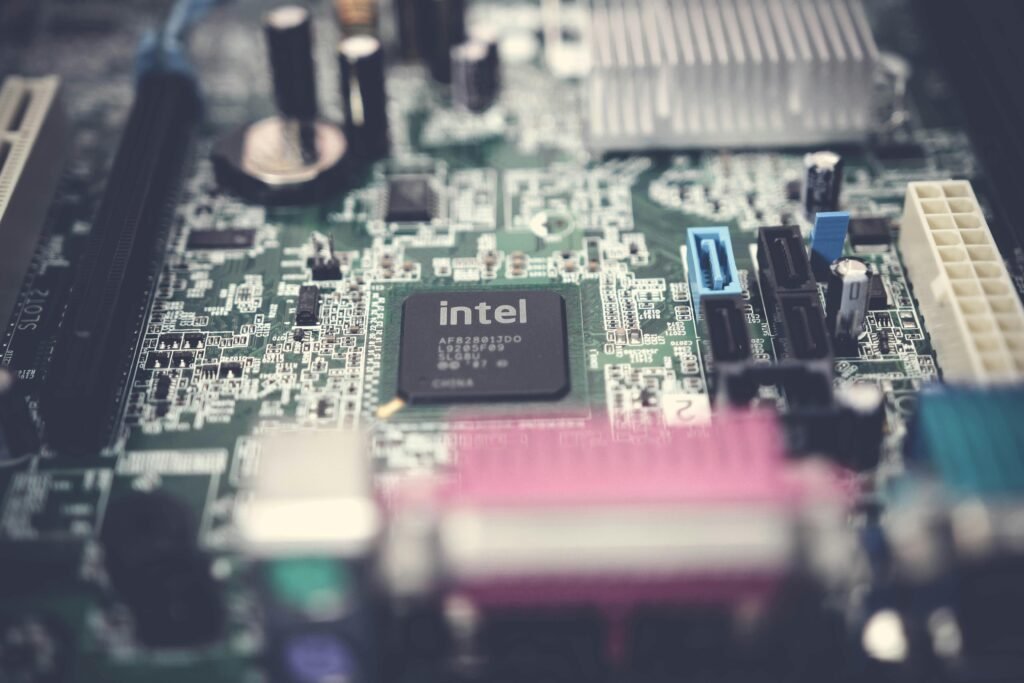 Detailed image of a computer motherboard highlighting an Intel chip with surrounding components.