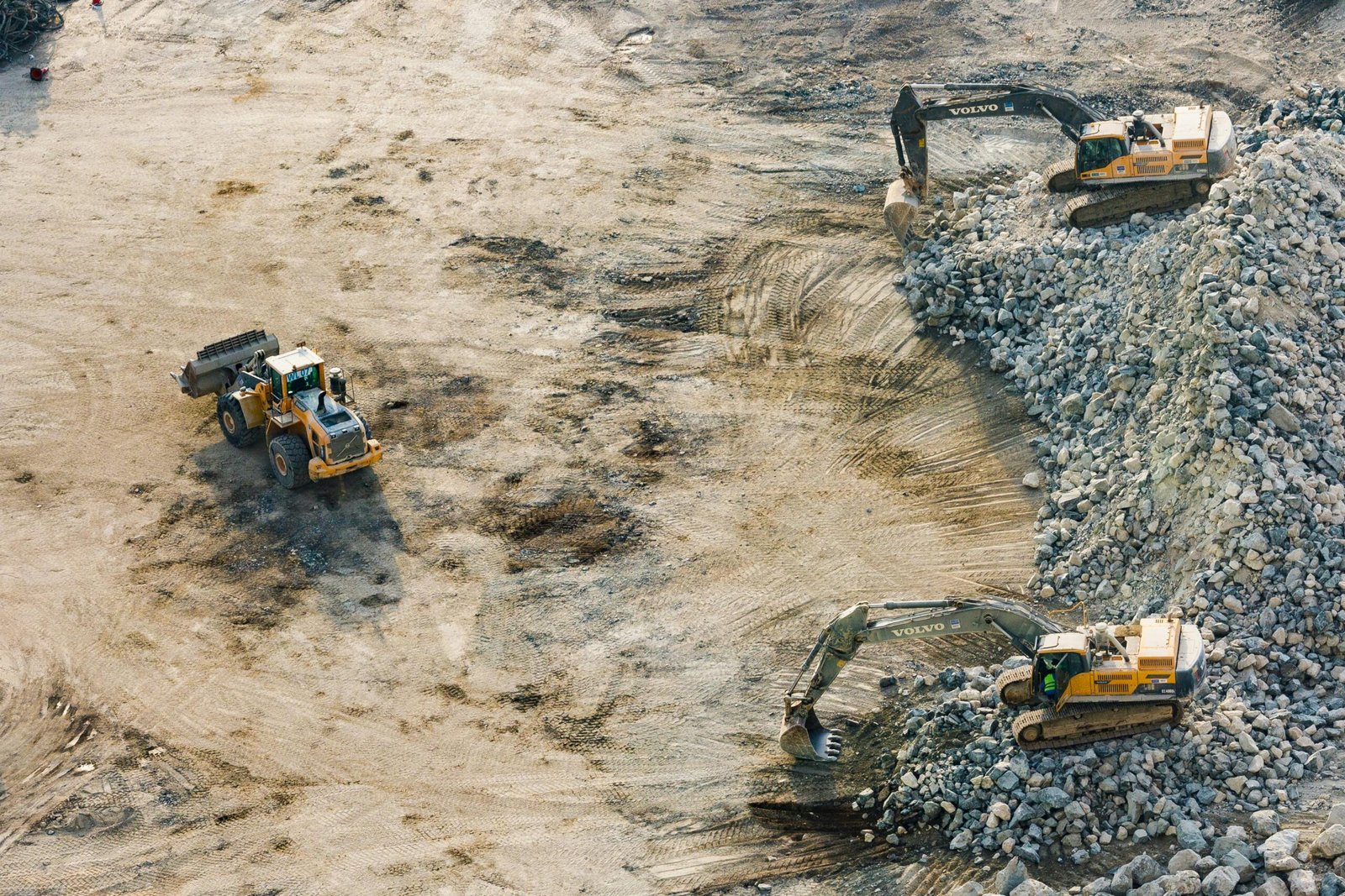 Aerial shot of heavy machinery working on a construction site in Dubai.