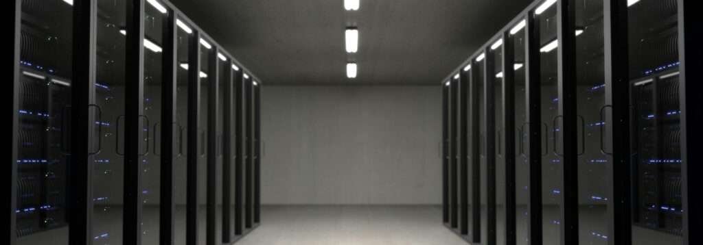Spacious data center with aligned server racks and LED indicators.
