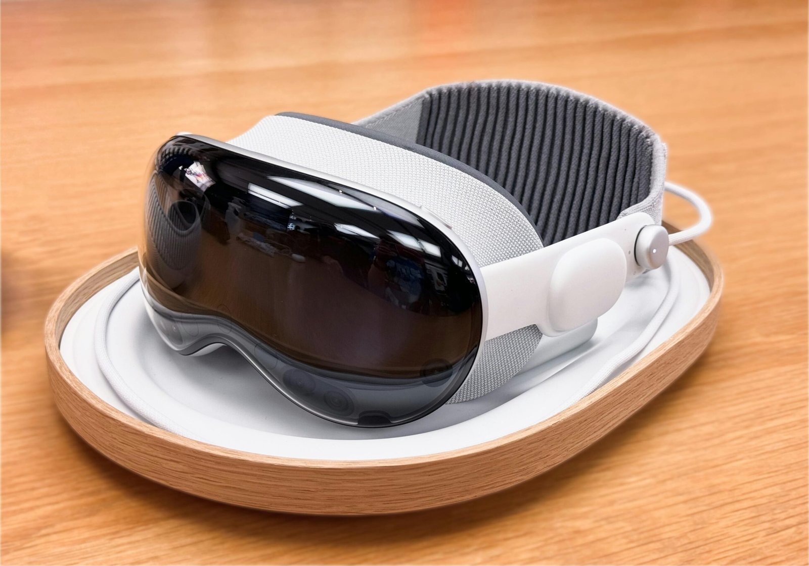 A sleek and modern virtual reality headset on a wooden surface.